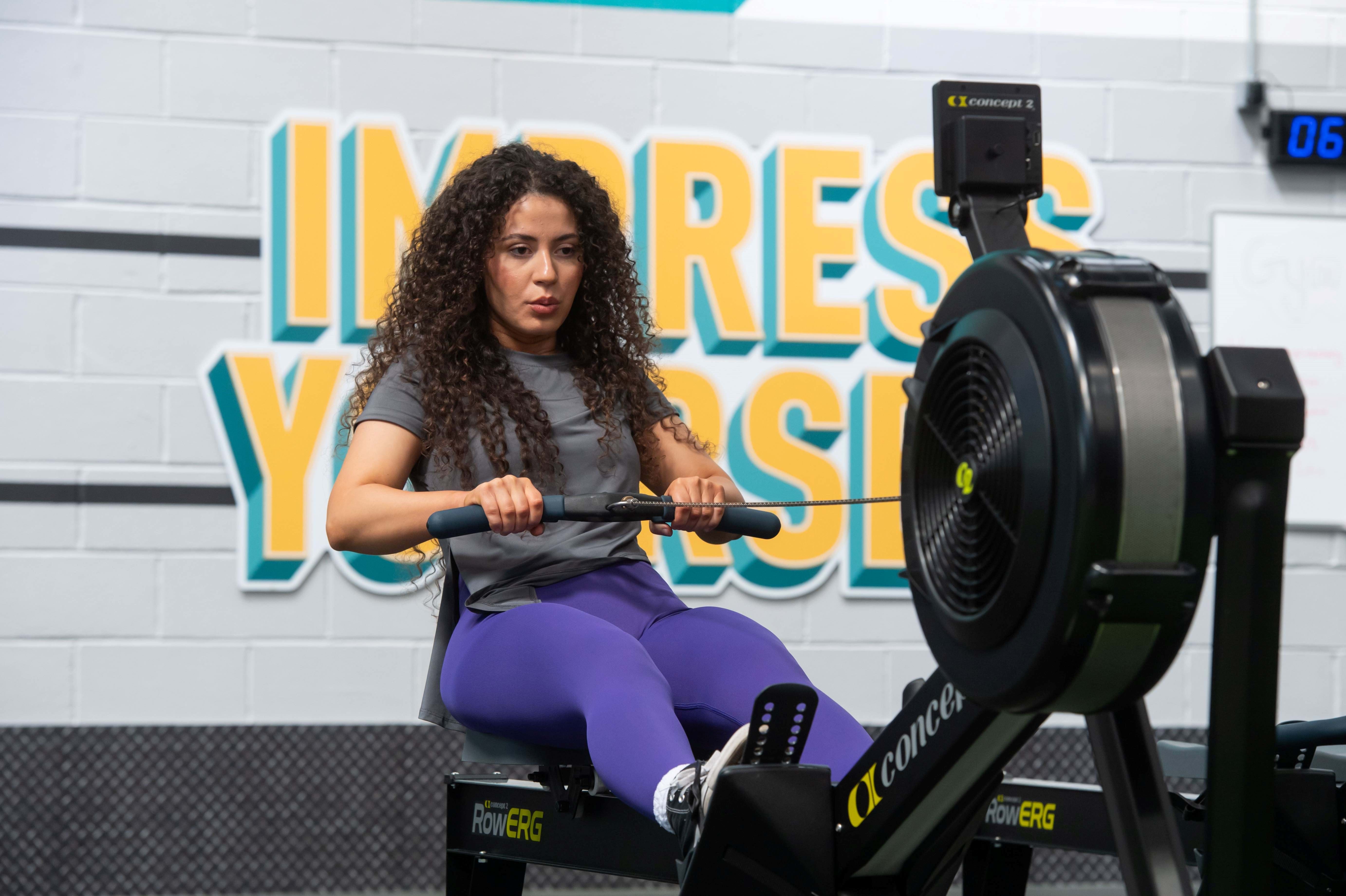 girl on rower in gym